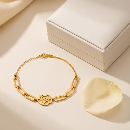 21K gold bracelet with a modern cutout flower charm and chic paperclip links designed for lightweight comfort and everyday luxury by Bafleh Jewellery.