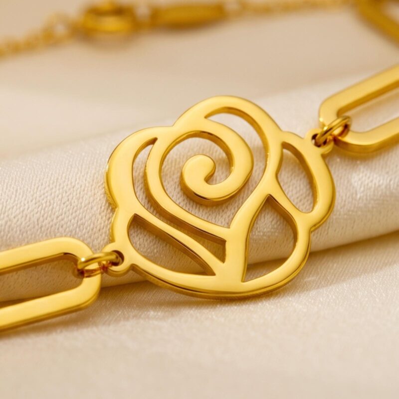 Alternative view of 21K gold bracelet with a modern cutout flower charm and chic paperclip links designed for lightweight comfort and everyday luxury by Bafleh Jewellery.