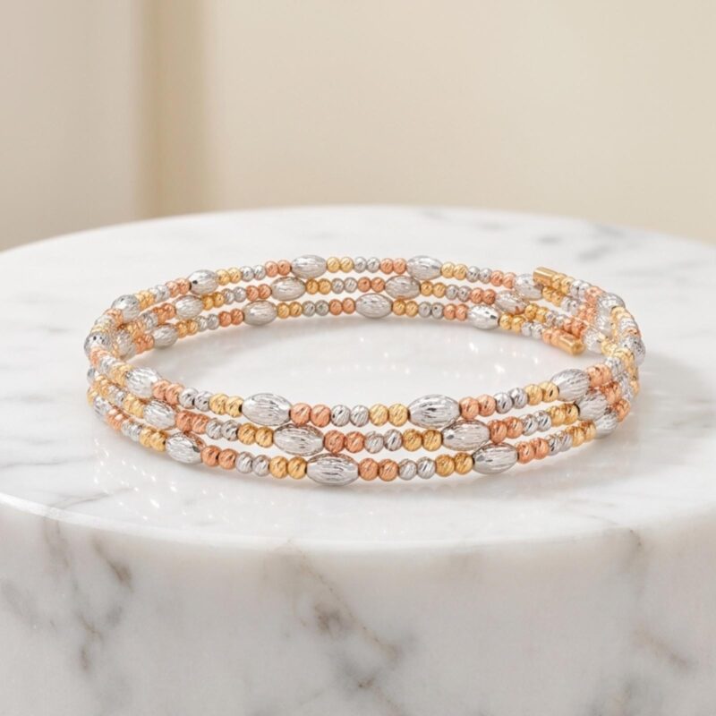 Add a Touch of Luxury to Your Look with the Exquisite Spring Bangle in 18K Gold with Intricate Beats Detailing